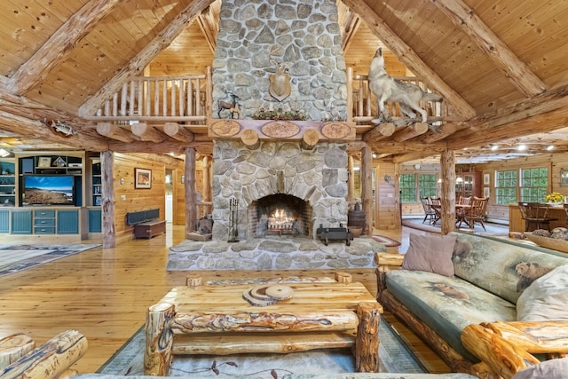 187 Chaplin Rd, Eastford, CT 06242 - living room with a stone fireplace, hardwood / wood-style flooring, a wood ceiling with exposed beams, high vaulted ceiling, and rustic walls