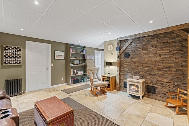 187 Chaplin Rd, Eastford, CT 06242 - living area with radiator, a wood stove, a drop ceiling, light tile patterned floors, and recessed lighting