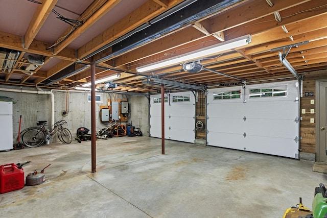 187 Chaplin Rd, Eastford, CT 06242 - garage featuring a garage door opener, electric panel, and freestanding refrigerator