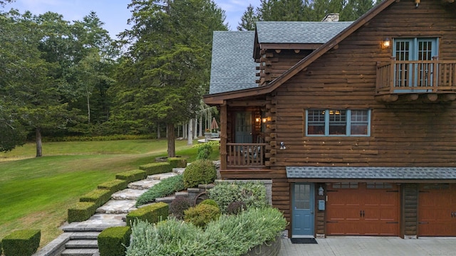 187 Chaplin Rd, Eastford, CT 06242 - view of front facade with log siding, a front yard, roof with shingles, a garage, and a chimney