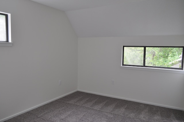 25 Heritage Dr Unit 25, Avon, CT 06001 - unfurnished room with dark carpet, plenty of natural light, and lofted ceiling