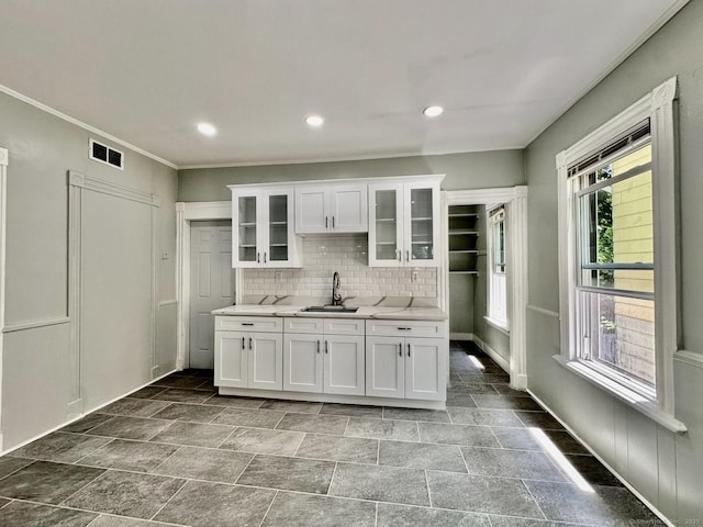 57 Houston St, New Haven, CT 06513 - kitchen featuring light countertops, white cabinets, glass insert cabinets, crown molding, and tasteful backsplash