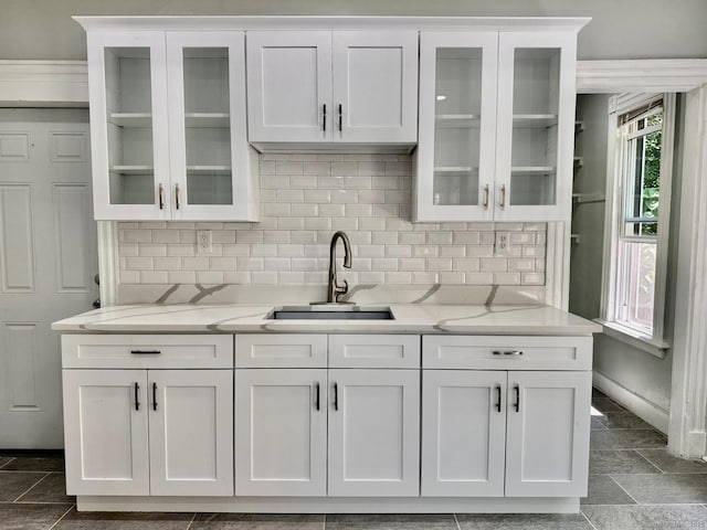 57 Houston St, New Haven, CT 06513 - kitchen with white cabinets, backsplash, glass insert cabinets, and light stone countertops