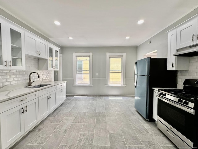 57 Houston St, New Haven, CT 06513 - kitchen featuring stainless steel gas range oven, under cabinet range hood, backsplash, white cabinets, and recessed lighting