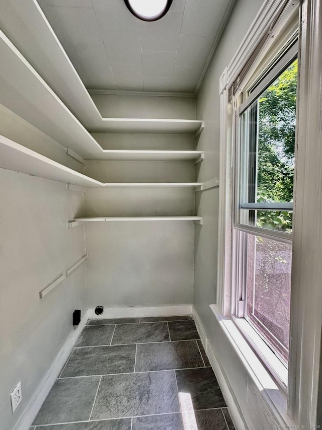 57 Houston St, New Haven, CT 06513 - laundry room with dark stone finish floors and crown molding