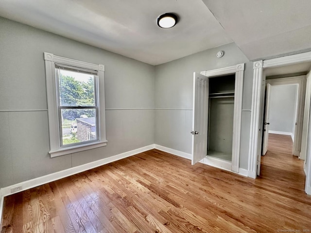 57 Houston St, New Haven, CT 06513 - unfurnished bedroom with wood finished floors and a closet