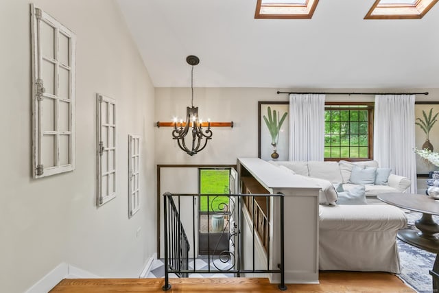 16 Pond Crest Rd, Danbury, CT 06811 - staircase featuring a skylight, a chandelier, vaulted ceiling, and wood finished floors