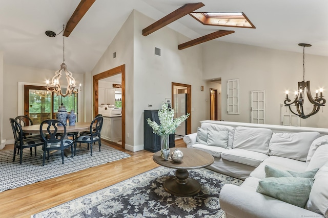 16 Pond Crest Rd, Danbury, CT 06811 - living area with a chandelier, beamed ceiling, light wood-style floors, and high vaulted ceiling