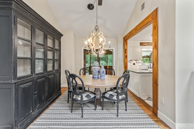 16 Pond Crest Rd, Danbury, CT 06811 - dining area featuring a chandelier, wood finished floors, and lofted ceiling
