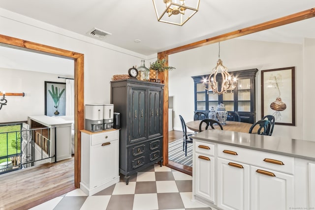16 Pond Crest Rd, Danbury, CT 06811 - kitchen with a chandelier, light floors, white cabinets, hanging light fixtures, and lofted ceiling