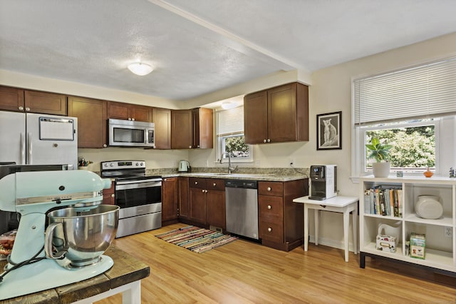 420 Newcomb Rd, North Kingston, Rhode Island, RI 02852 - kitchen with appliances with stainless steel finishes, light wood-type flooring, and light stone counters