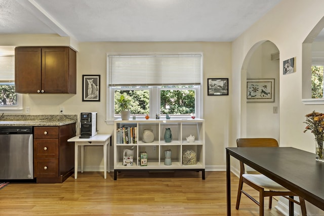 420 Newcomb Rd, North Kingston, Rhode Island, RI 02852 - kitchen with stainless steel dishwasher, light wood-style floors, arched walkways, and healthy amount of natural light