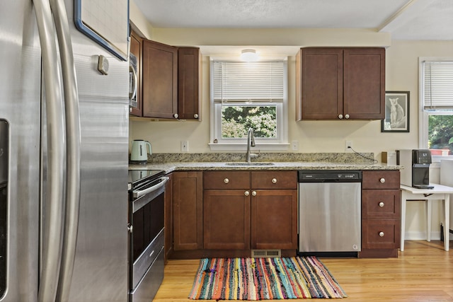 420 Newcomb Rd, North Kingston, Rhode Island, RI 02852 - kitchen with stainless steel appliances, light wood-style flooring, and light stone counters