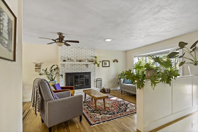 420 Newcomb Rd, North Kingston, Rhode Island, RI 02852 - living area with a ceiling fan, a textured ceiling, a fireplace, hardwood / wood-style flooring, and recessed lighting