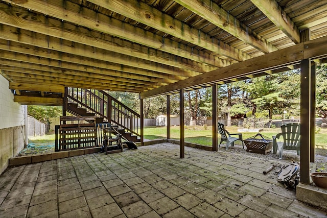 420 Newcomb Rd, North Kingston, Rhode Island, RI 02852 - fenced backyard featuring a fire pit, a shed, stairs, and a patio area