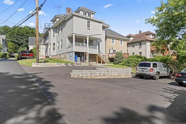 36 Taylor Ave, Norwalk, CT 06854 - view of front of home featuring uncovered parking and a chimney