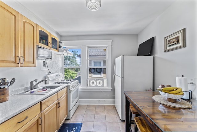 36 Taylor Ave, Norwalk, CT 06854 - kitchen featuring white appliances, light countertops, light tile patterned floors, glass insert cabinets, and light brown cabinetry