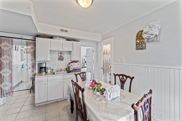 36 Taylor Ave, Norwalk, CT 06854 - dining room featuring wainscoting, light tile patterned floors, and crown molding