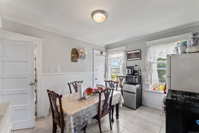36 Taylor Ave, Norwalk, CT 06854 - dining area featuring wainscoting, light tile patterned floors, and crown molding