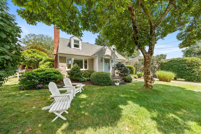 33 Ridgeley St, Darien, CT 06820 - cape cod-style house featuring a chimney, a front yard, stone siding, and roof with shingles