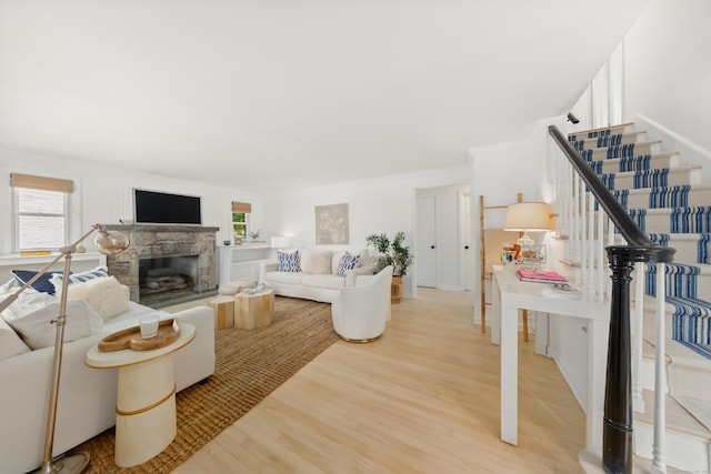 33 Ridgeley St, Darien, CT 06820 - living area featuring plenty of natural light, light wood finished floors, stairway, and a fireplace