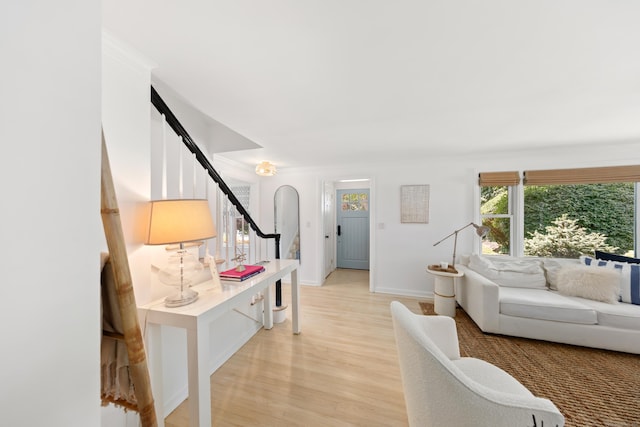 33 Ridgeley St, Darien, CT 06820 - living area featuring stairway, arched walkways, and light wood-type flooring
