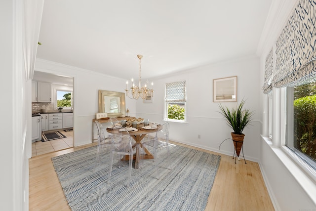 33 Ridgeley St, Darien, CT 06820 - dining area with a chandelier, light wood finished floors, and ornamental molding