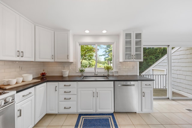 33 Ridgeley St, Darien, CT 06820 - kitchen with stainless steel dishwasher, dark countertops, decorative backsplash, and recessed lighting