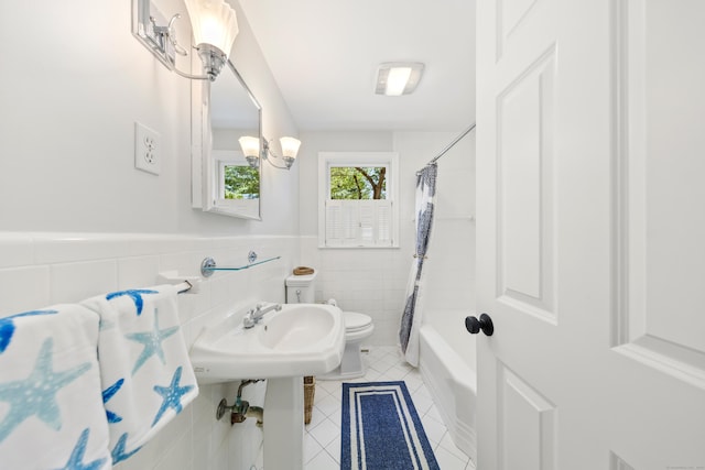 33 Ridgeley St, Darien, CT 06820 - full bathroom with tile patterned flooring, tile walls, shower / bath combination with curtain, and a wainscoted wall
