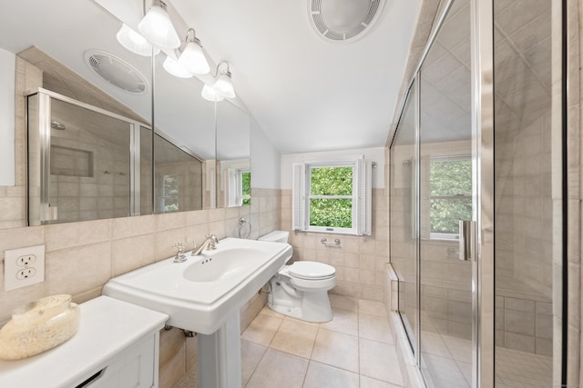 33 Ridgeley St, Darien, CT 06820 - bathroom featuring tile walls, vaulted ceiling, tile patterned flooring, and a shower stall