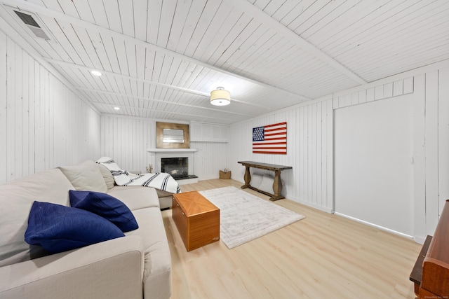 33 Ridgeley St, Darien, CT 06820 - living area with wood finished floors, a fireplace with raised hearth, wooden walls, and wood ceiling