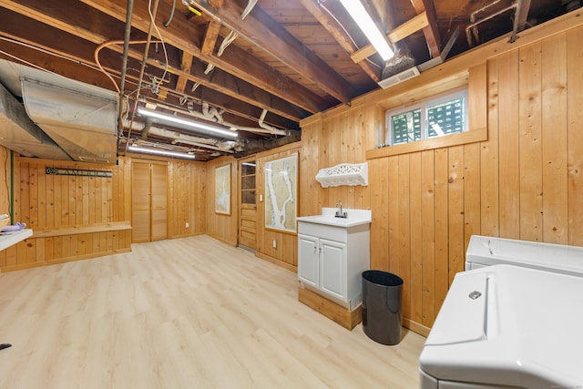 33 Ridgeley St, Darien, CT 06820 - laundry area with cabinet space, wood walls, light wood finished floors, and washer and dryer