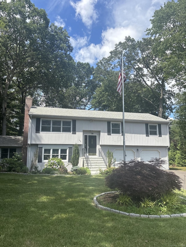 18 Belleview Dr, Derby, CT 06418 - bi-level home featuring an attached garage, a front lawn, a chimney, and entry steps