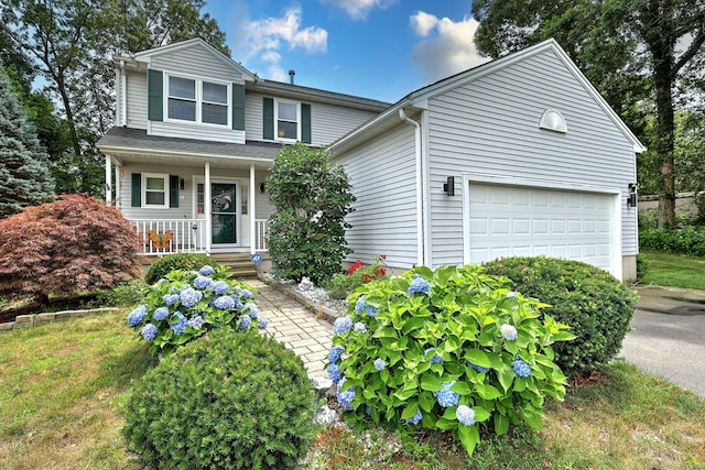 68 Benjamin Rd, East Haven, CT 06513 - view of front facade with a porch, asphalt driveway, and an attached garage