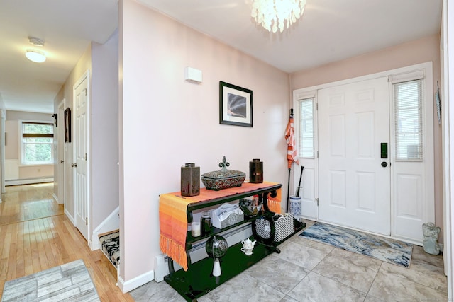68 Benjamin Rd, East Haven, CT 06513 - entrance foyer with baseboard heating, light wood-style floors, and a chandelier
