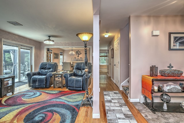 68 Benjamin Rd, East Haven, CT 06513 - living room featuring wood finished floors, plenty of natural light, and a chandelier