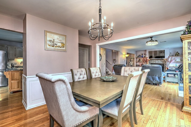 68 Benjamin Rd, East Haven, CT 06513 - dining area featuring light wood-style flooring and a chandelier