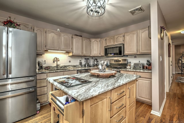 68 Benjamin Rd, East Haven, CT 06513 - kitchen featuring stainless steel appliances, light wood-type flooring, a kitchen island, light stone counters, and light brown cabinetry