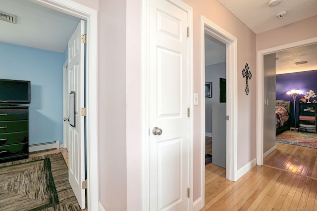 68 Benjamin Rd, East Haven, CT 06513 - hall featuring baseboard heating and light wood finished floors