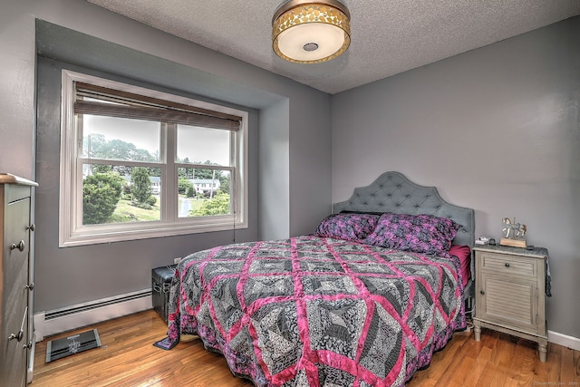 68 Benjamin Rd, East Haven, CT 06513 - bedroom with a baseboard radiator, wood finished floors, and a textured ceiling
