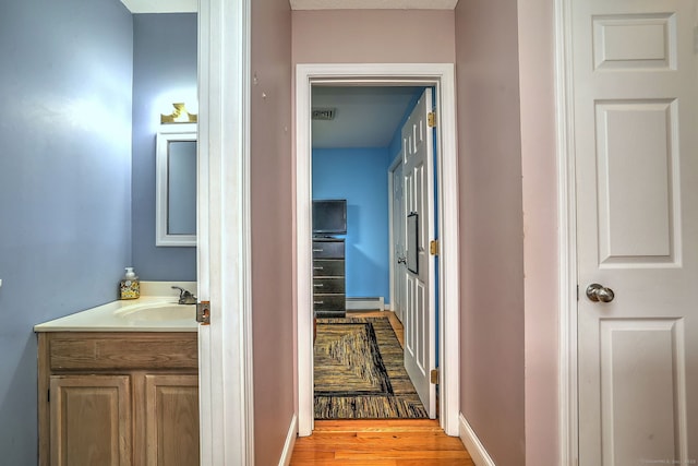 68 Benjamin Rd, East Haven, CT 06513 - corridor featuring a baseboard radiator and wood finished floors