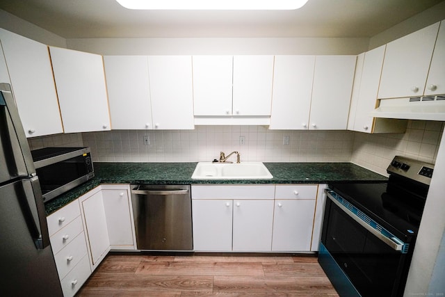 50 E Hill Rd Apt 2H, Canton, CT 06019 - kitchen with stainless steel appliances, under cabinet range hood, light wood-type flooring, white cabinets, and tasteful backsplash