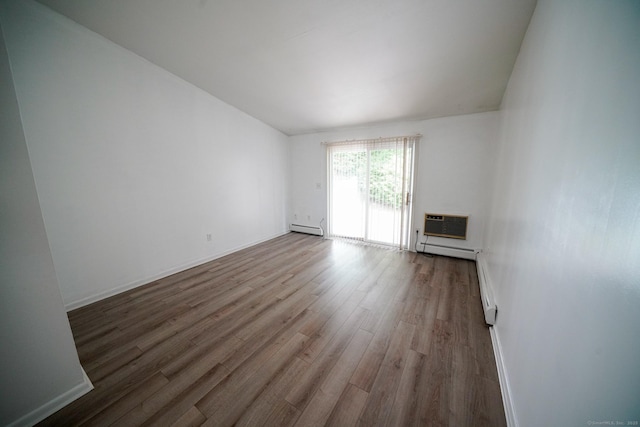 50 E Hill Rd Apt 2H, Canton, CT 06019 - unfurnished living room featuring baseboard heating, wood finished floors, and a wall mounted AC