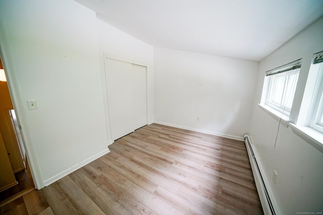 50 E Hill Rd Apt 2H, Canton, CT 06019 - unfurnished bedroom with baseboard heating, light wood finished floors, and a closet