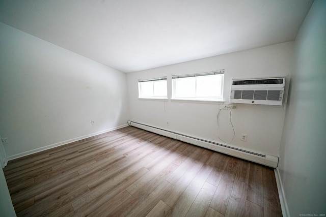50 E Hill Rd Apt 2H, Canton, CT 06019 - spare room featuring a baseboard radiator, wood finished floors, and a wall mounted AC