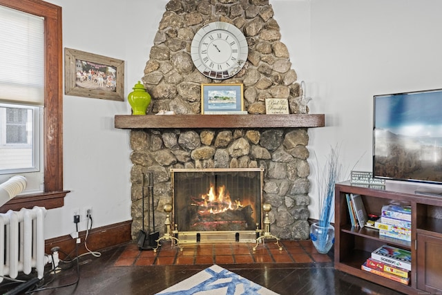 1176 Ocean Ave, New London, CT 06320 - living area with radiator heating unit, a fireplace, and wood finished floors