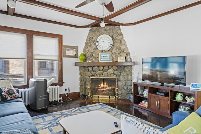 1176 Ocean Ave, New London, CT 06320 - living room featuring radiator, wood finished floors, ceiling fan, beamed ceiling, and a stone fireplace