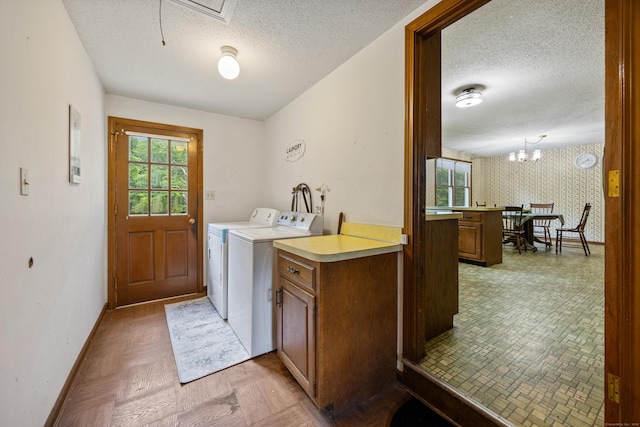 229 Flanders Rd, Southington, CT 06489 - laundry room with washer and dryer, a textured ceiling, healthy amount of natural light, and a chandelier
