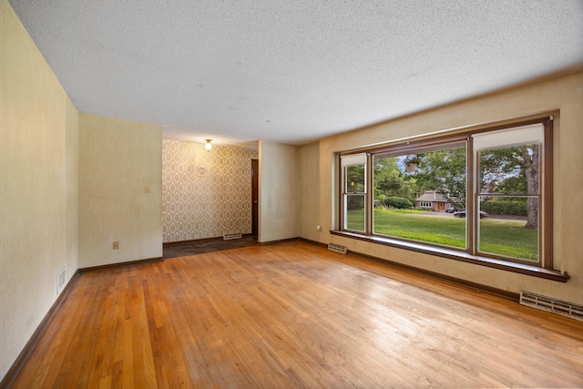 229 Flanders Rd, Southington, CT 06489 - unfurnished room with hardwood / wood-style floors and a textured ceiling