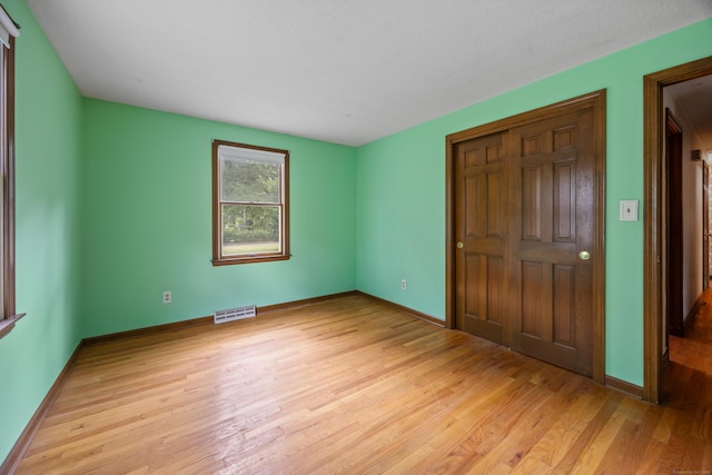 229 Flanders Rd, Southington, CT 06489 - unfurnished bedroom with light wood-style floors and a closet